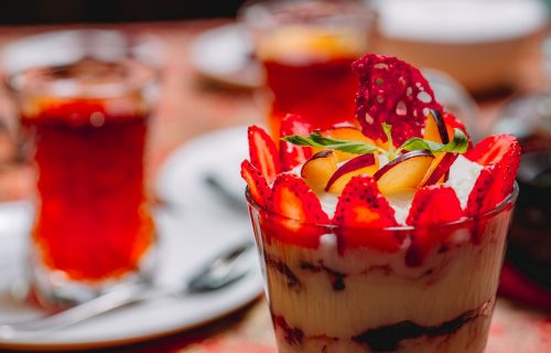 side view dessert tiramisu with sliced ??strawberries and apple